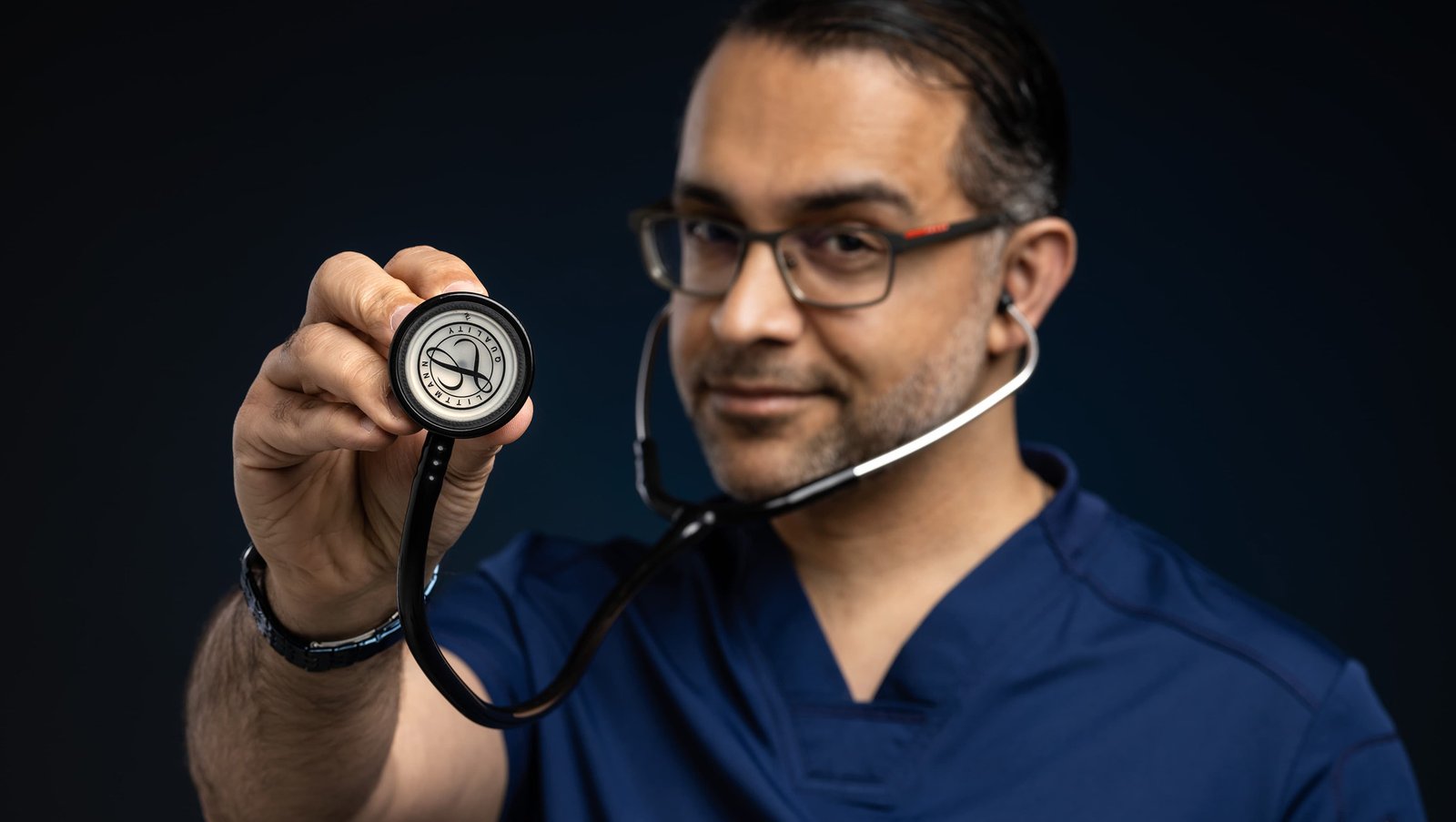 Dr. Siya holding a stethoscope toward the camera