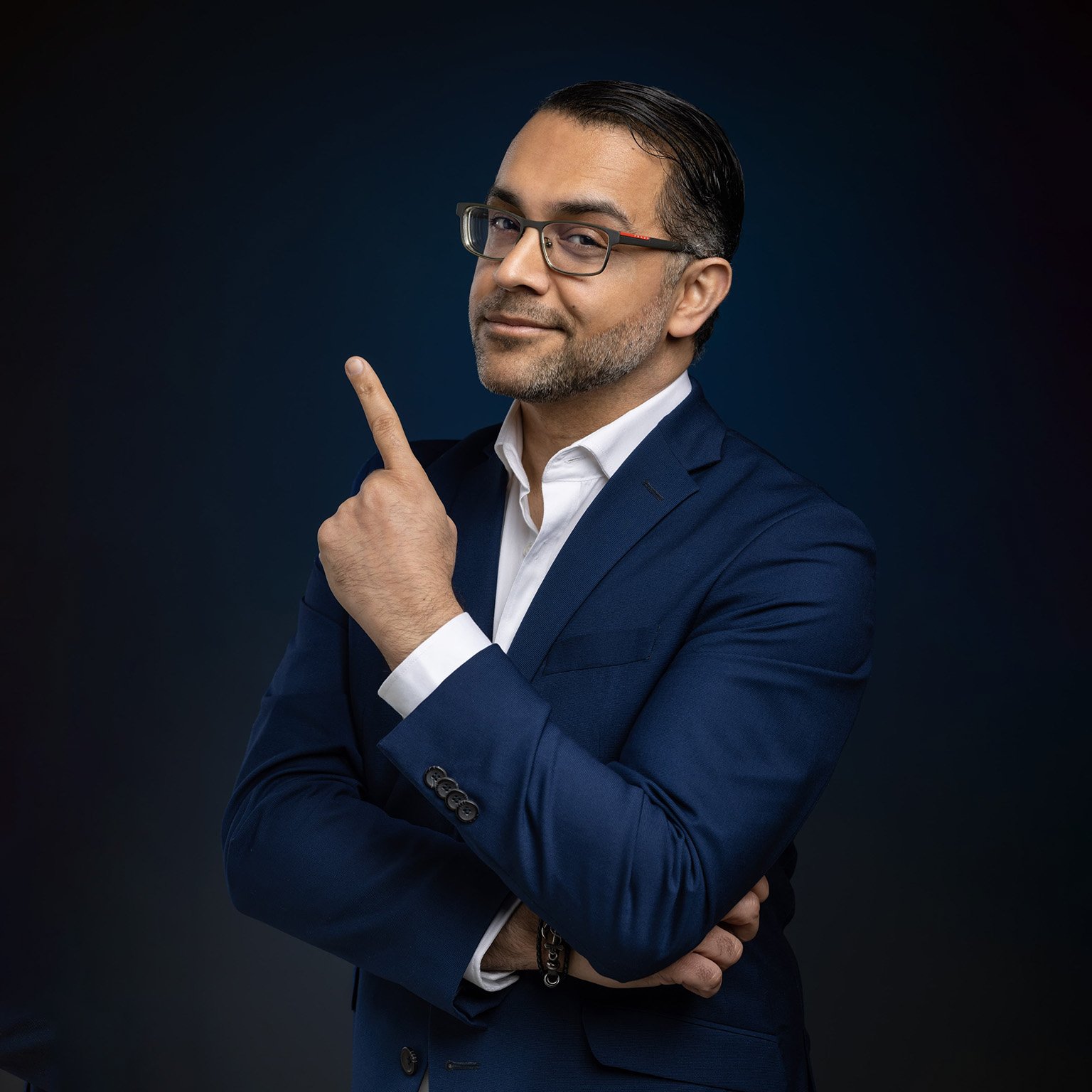 Dr. Siya in a navy suit